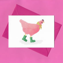 Load image into Gallery viewer, A stylised watercolour illustration of a pink chicken, wearing a yellow scarf with green flowers around its neck, and green wellies on its feet, on a greeting card. With a bright pink envelope on a pink background.
