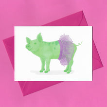 Load image into Gallery viewer, A stylised watercolour illustration of a green pig wearing a purple tutu on a greeting card, with a bright pink envelope, on a pink background
