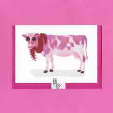 Load image into Gallery viewer, A stylised watercolour illustration on a greeting card of a pink and white cow, wearing sunglasses and a red scarf, with a bright pink envelope held together by an eco friendly plastic free card catch sticker, on a pink background
