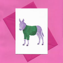 Load image into Gallery viewer, A stylised watercolour illustration on a greeting card of a purple donkey wearing a green zigzag patterned jumper, with a bright pink envelope, on a pink background
