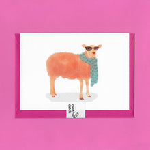 Load image into Gallery viewer, A stylised watercolour illustration on a greeting card of a tangerine coloured sheep wearing sunglasses and a blue scarf, with a bright pink envelope held together by an eco friendly plastic free card catch sticker, on a pink background
