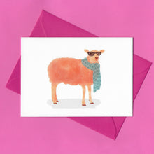 Load image into Gallery viewer, A stylised watercolour illustration on a greeting card of a tangerine coloured sheep wearing sunglasses and a blue scarf, with a bright pink envelope, on a pink background
