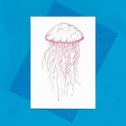 A detailed colour illustration on a luxury greeting card of a pale pink coloured jellyfish, with a kingfisher blue envelope, sitting on a blue background